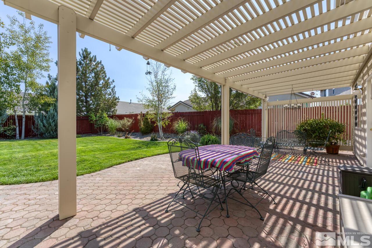 10650 Silver Cliff Way Reno, NV 89521 - Photo 35 of 38 a view of a patio with a table chairs and a backyard
