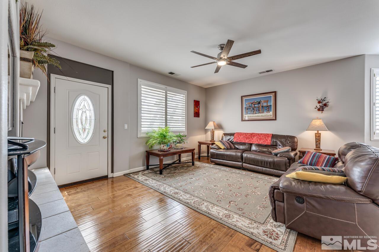 10650 Silver Cliff Way Reno, NV 89521 - Photo 6 of 38 a living room with furniture a window and a clock