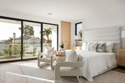 a bedroom with a large bed and large window with outer view