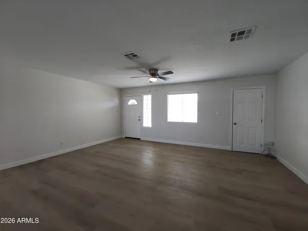 an empty room with a empty space and windows