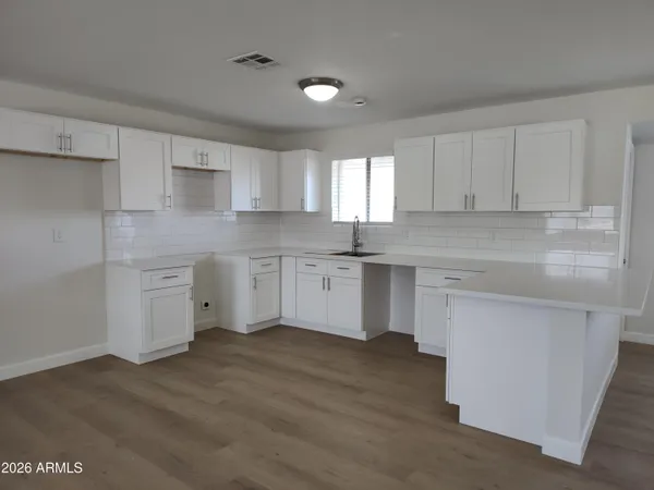 a kitchen with a sink cabinets and window
