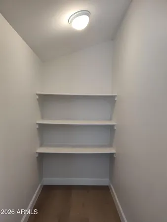 a view of an empty room with ceiling fan