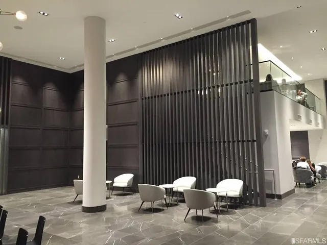 a living room with furniture and a lamp