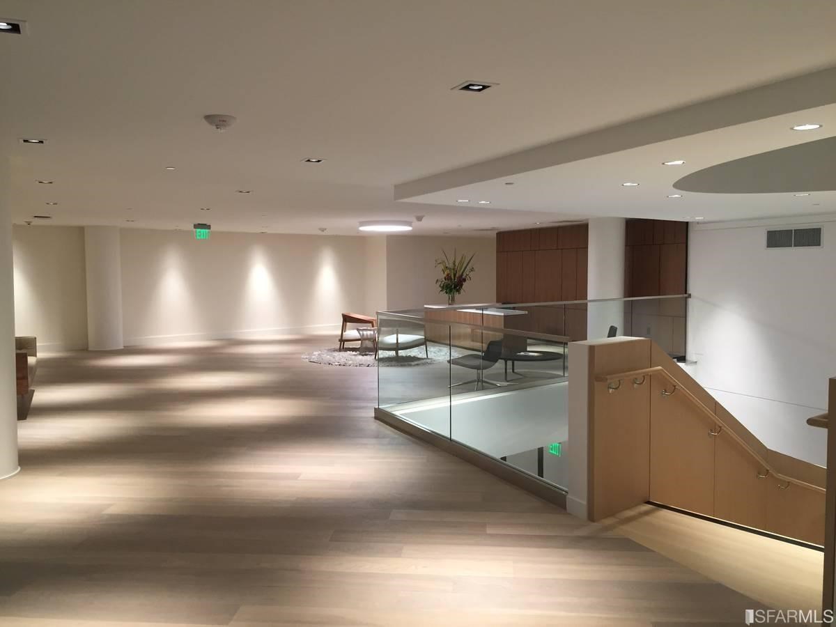 338 Main Street, Unit 27D San Francisco, CA 94105 - Photo 14 of 24 a view of gym equipment and kitchen view