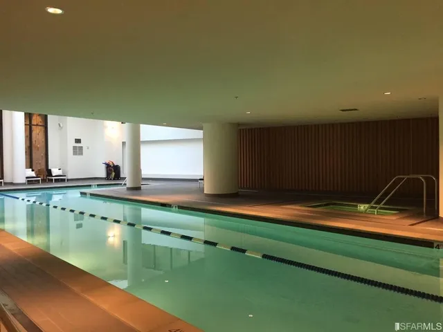 a living room with furniture gym equipment and a flat screen tv