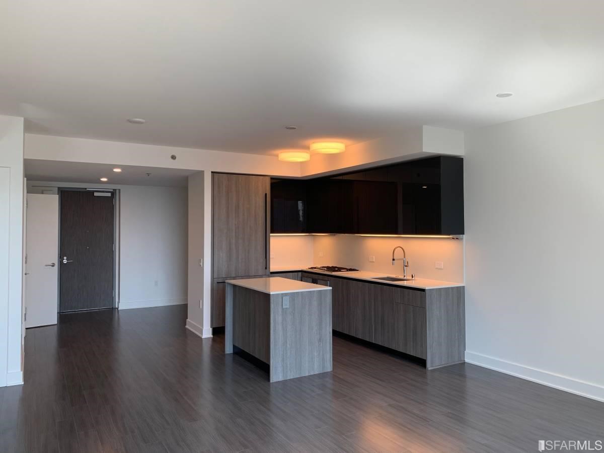338 Main Street, Unit 27D San Francisco, CA 94105 - Photo 5 of 24 a view of kitchen with stainless steel appliances wooden floor and wooden cabinets