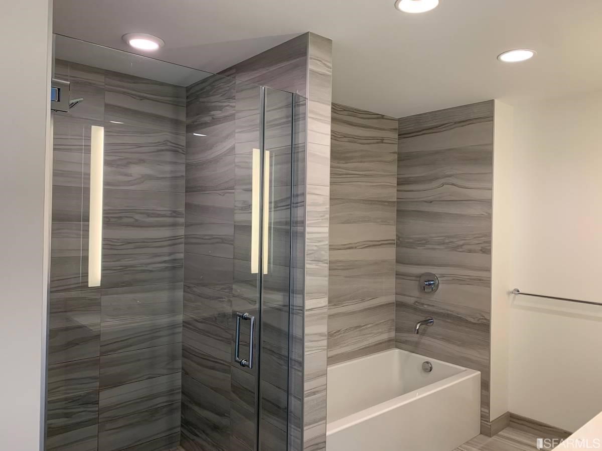 338 Main Street, Unit 27D San Francisco, CA 94105 - Photo 8 of 24 a bathroom with a bathtub and shower