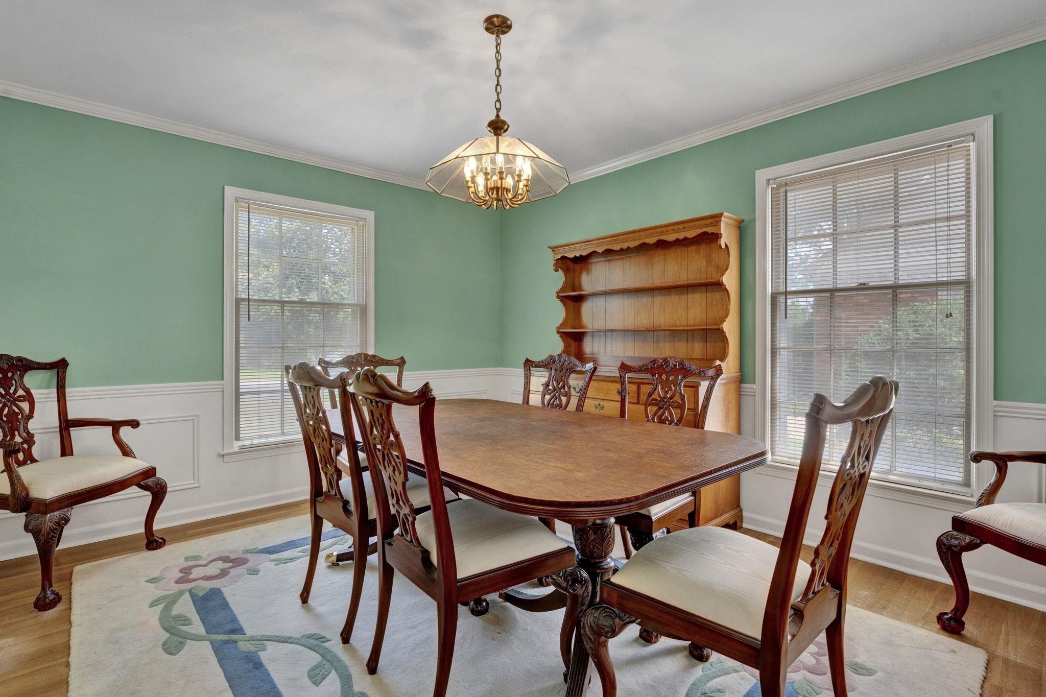 87 North Oak Grove Road Memphis, TN 38120 - Photo 12 of 25 a view of a dining room with furniture wooden floor and a chandelier