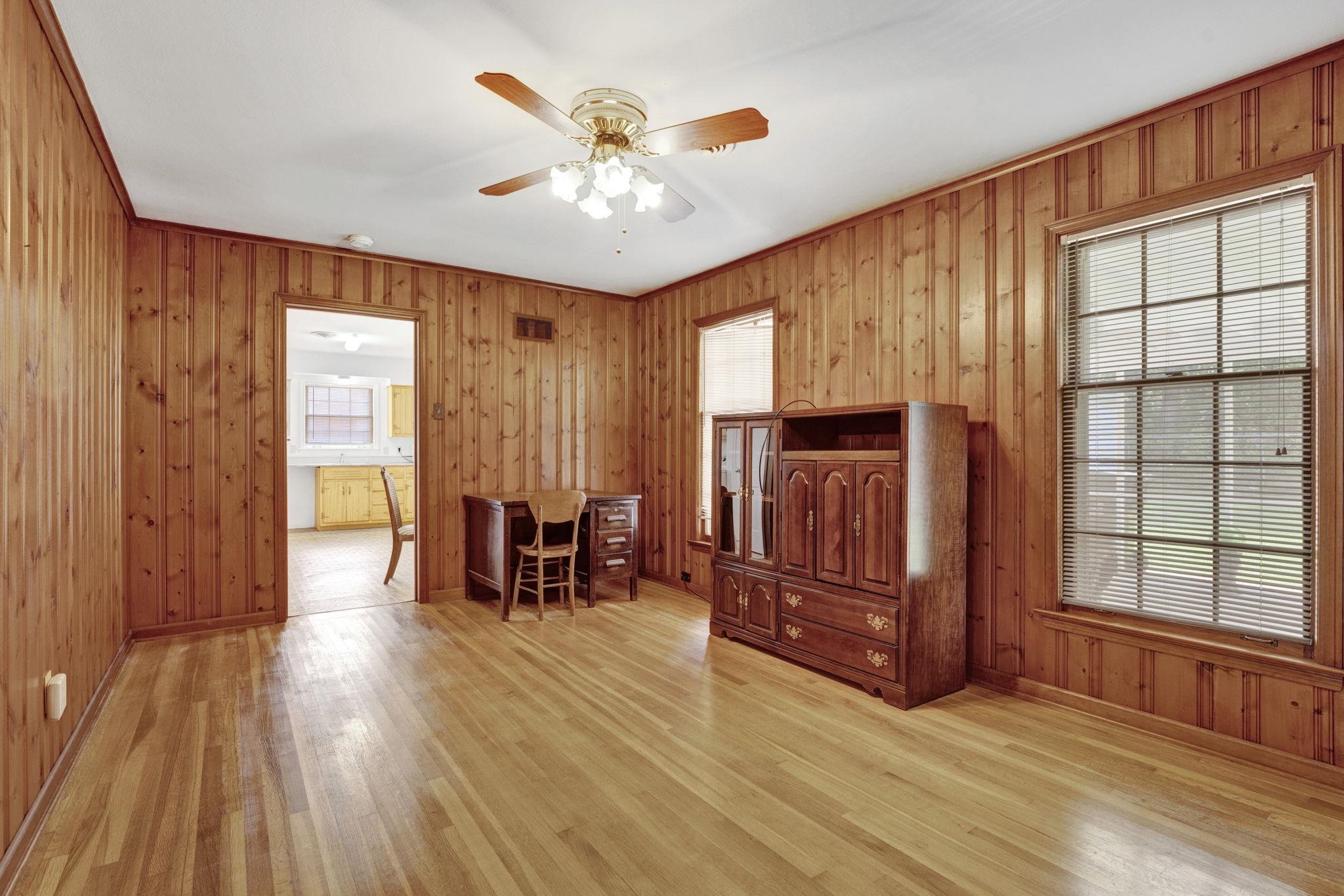 87 North Oak Grove Road Memphis, TN 38120 - Photo 6 of 25 an empty room with wooden floor fireplace and windows