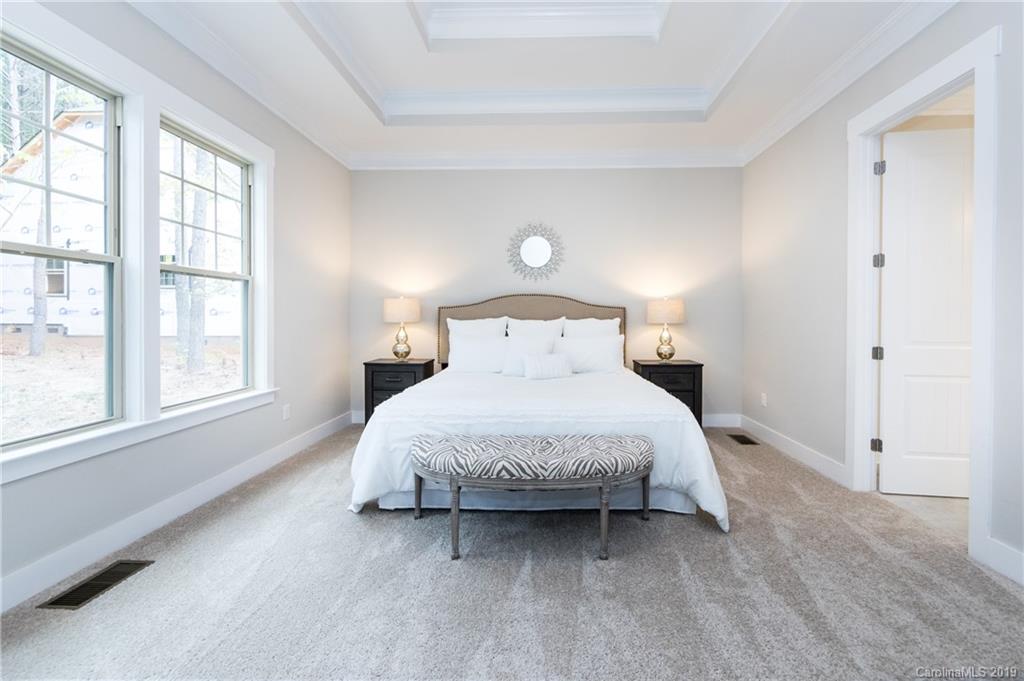 136 Streamwood Road, Unit 17 Troutman, NC 28166 - Photo 22 of 43 a bed room with a bed and a large window