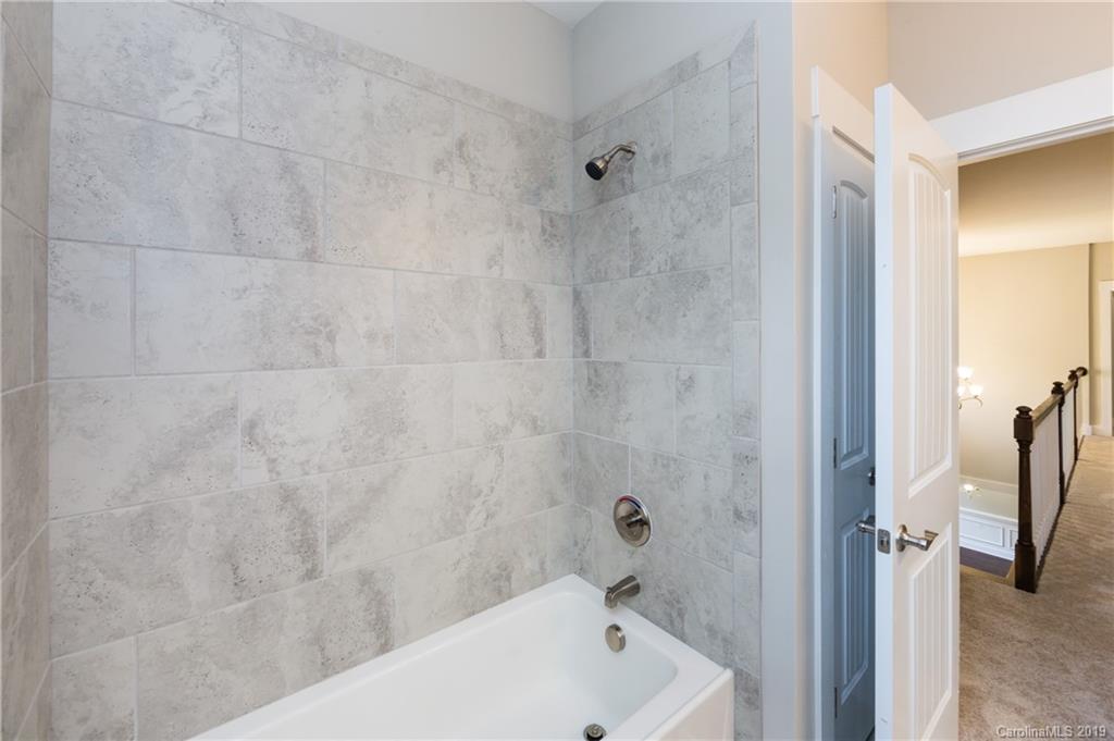 136 Streamwood Road, Unit 17 Troutman, NC 28166 - Photo 40 of 43 a bathroom with a white bath tub and a shower