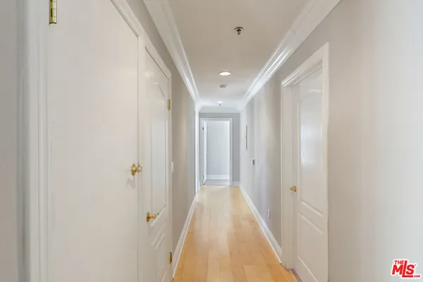 a view of a hallway with wooden floor