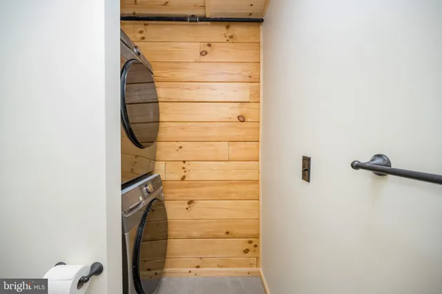 a bedroom with a bed a window and a flat screen tv