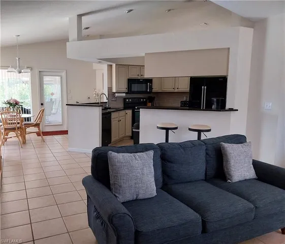 a bedroom with a bed and a large mirror