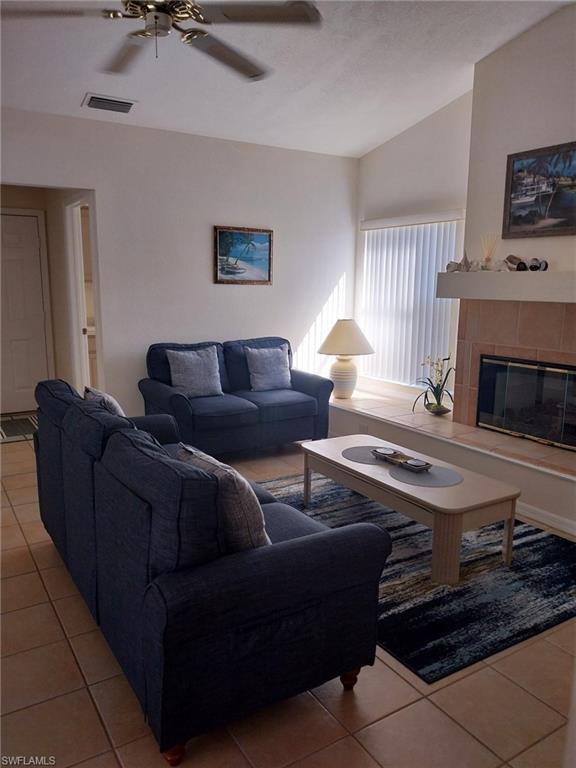 449 Dundee Court Naples, FL 34104 - Photo 15 of 35 a living room with furniture and a fireplace