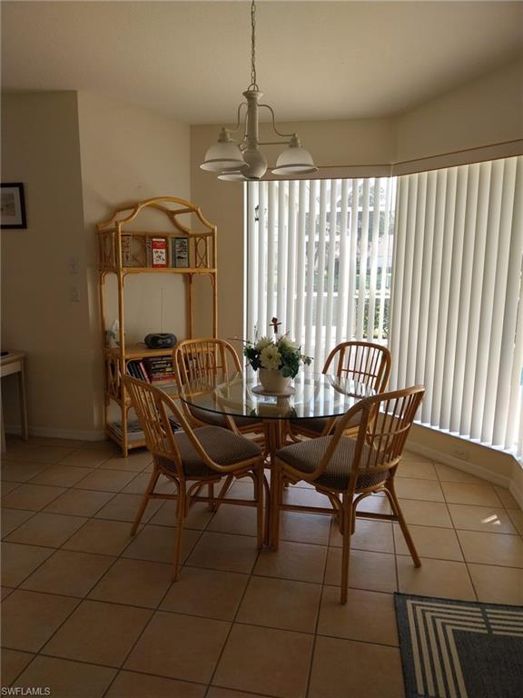449 Dundee Court Naples, FL 34104 - Photo 16 of 35 a view of a dining room with furniture and window