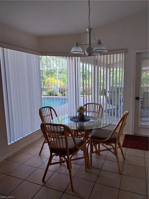 449 Dundee Court Naples, FL 34104 - Photo 17 of 35 a view of a dining room with furniture window and outside view