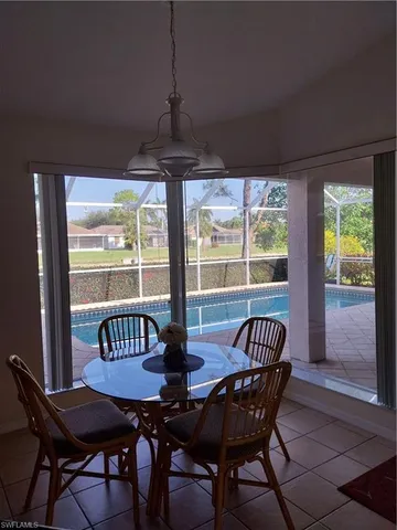 a bedroom with a bed a dresser and a window