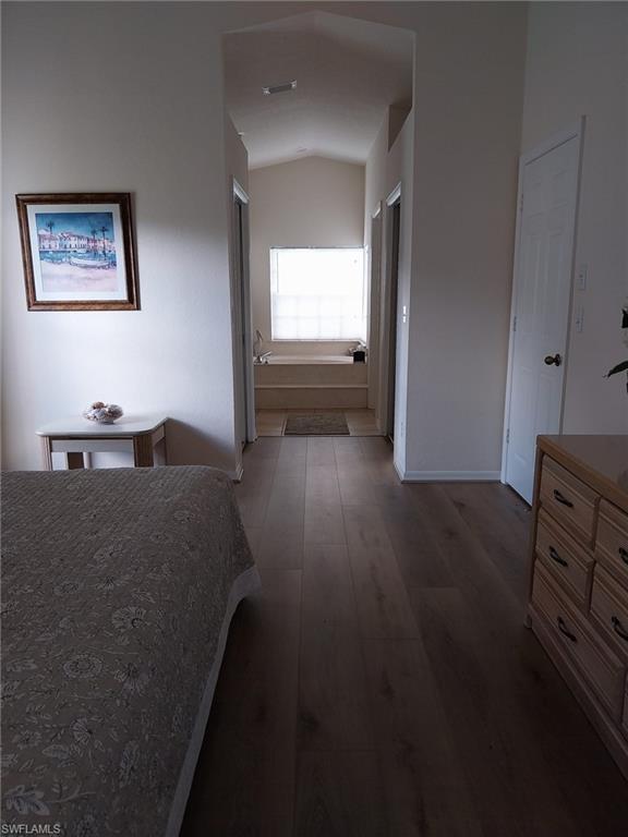 449 Dundee Court Naples, FL 34104 - Photo 22 of 35 Bedroom featuring dark wood-style floors and lofted ceiling