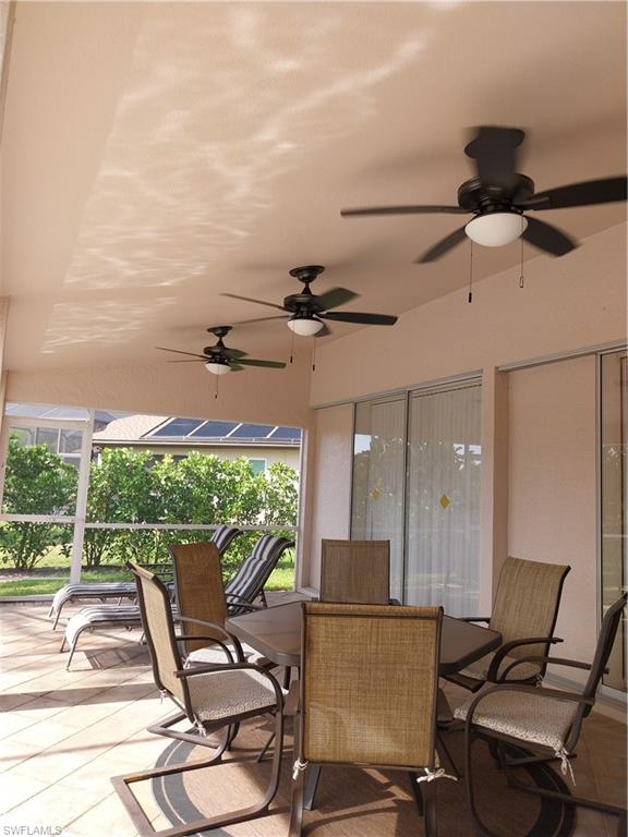 449 Dundee Court Naples, FL 34104 - Photo 32 of 35 a view of a patio with table and chairs