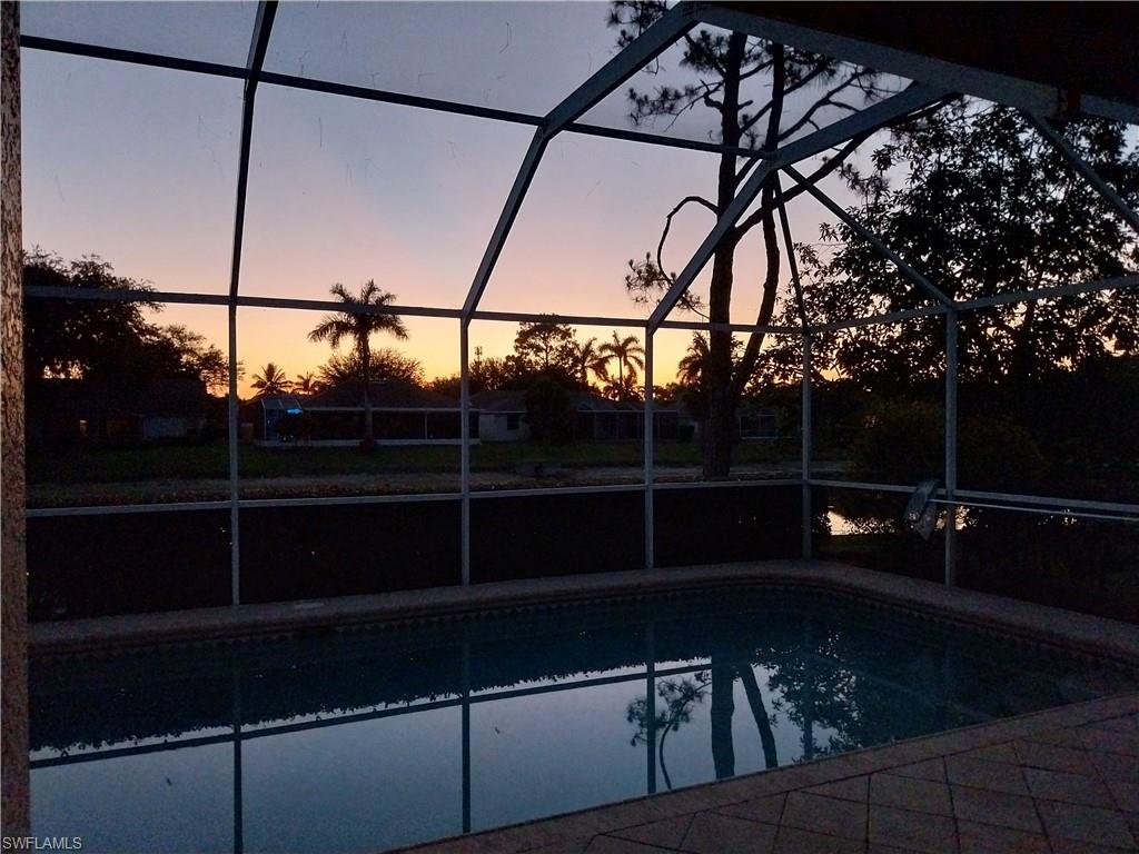 449 Dundee Court Naples, FL 34104 - Photo 33 of 35 Outdoor pool with a lanai