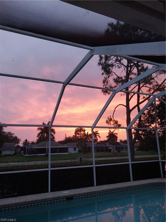 449 Dundee Court Naples, FL 34104 - Photo 34 of 35 Outdoor pool featuring glass enclosure