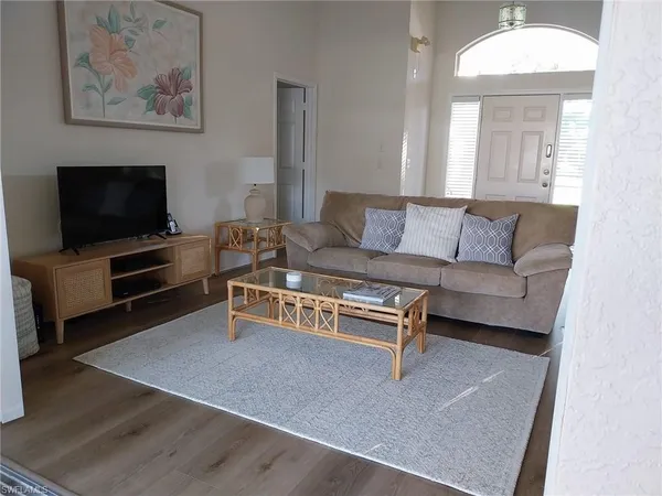 a living room with furniture a fireplace and a window