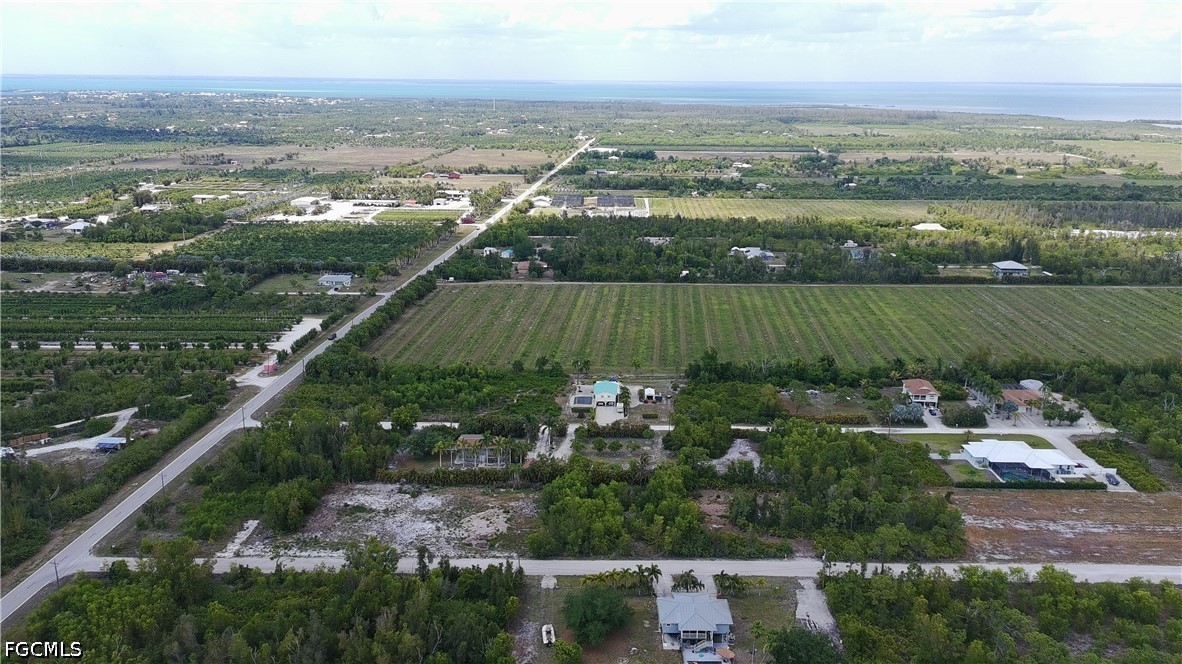 6430 Mannheim Road Bokeelia, FL 33922 - Photo 6 of 9 an aerial view of a city with lots of residential buildings lake and mountain view in back