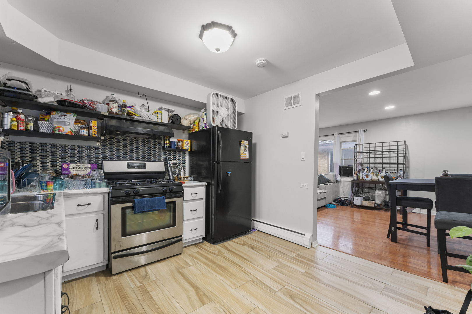 5121 West Diversey Avenue, Unit 3S Chicago, IL 60639 - Photo 2 of 9 a kitchen with stainless steel appliances granite countertop a stove and a refrigerator
