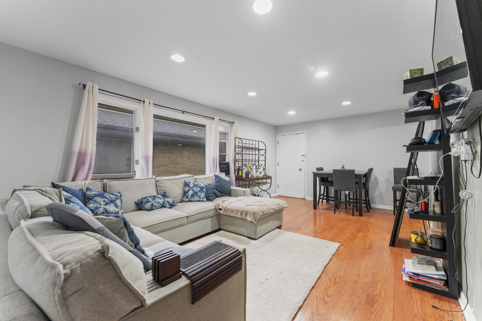 5121 West Diversey Avenue, Unit 3S Chicago, IL 60639 - Photo 3 of 9 a living room with lots of furniture and a flat screen tv