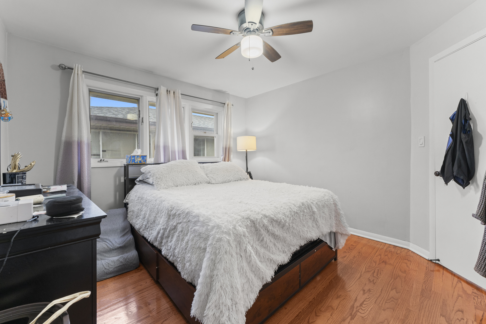 5121 West Diversey Avenue, Unit 3S Chicago, IL 60639 - Photo 5 of 9 a bedroom with a bed and a chandelier