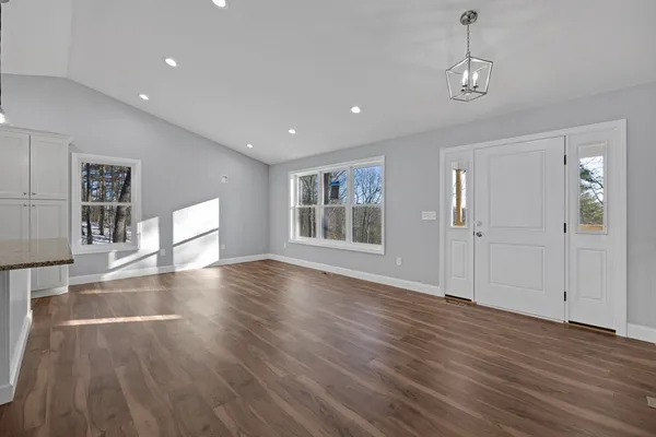 a view of a livingroom with wooden floor and window
