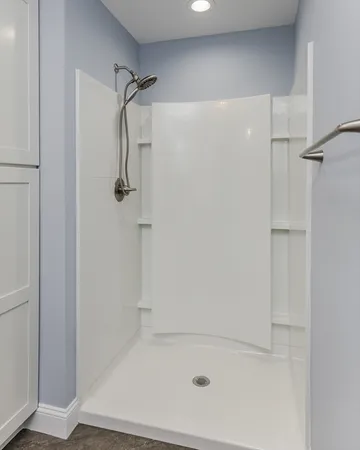 a bathroom with a granite countertop toilet a sink and a window