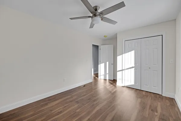 a bathroom with a granite countertop sink toilet and mirror