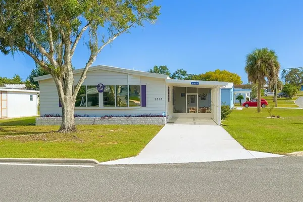 a view of house with a swimming pool