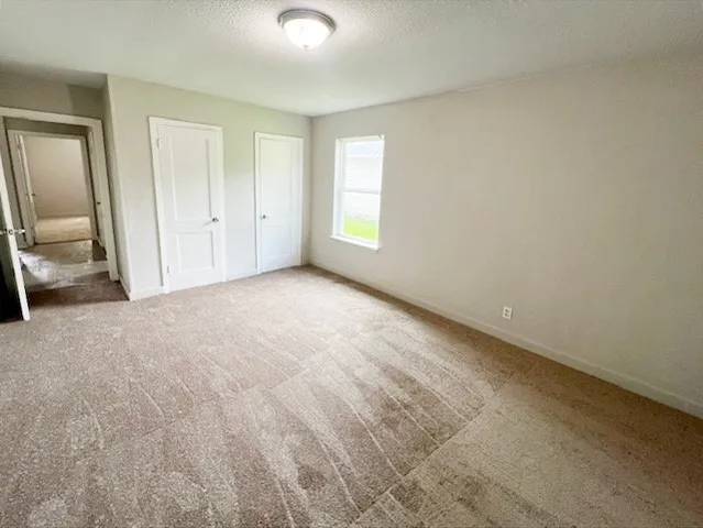 an empty room with a window and windows