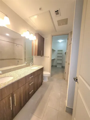 a large bathroom with a sink mirror and a shower