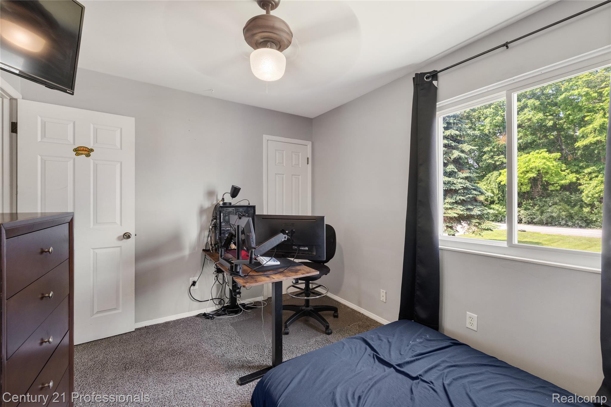 15037 Hogan Road Linden, MI 48451 - Photo 22 of 38 Room featuring a large window, light gray walls, and textured carpet flooring