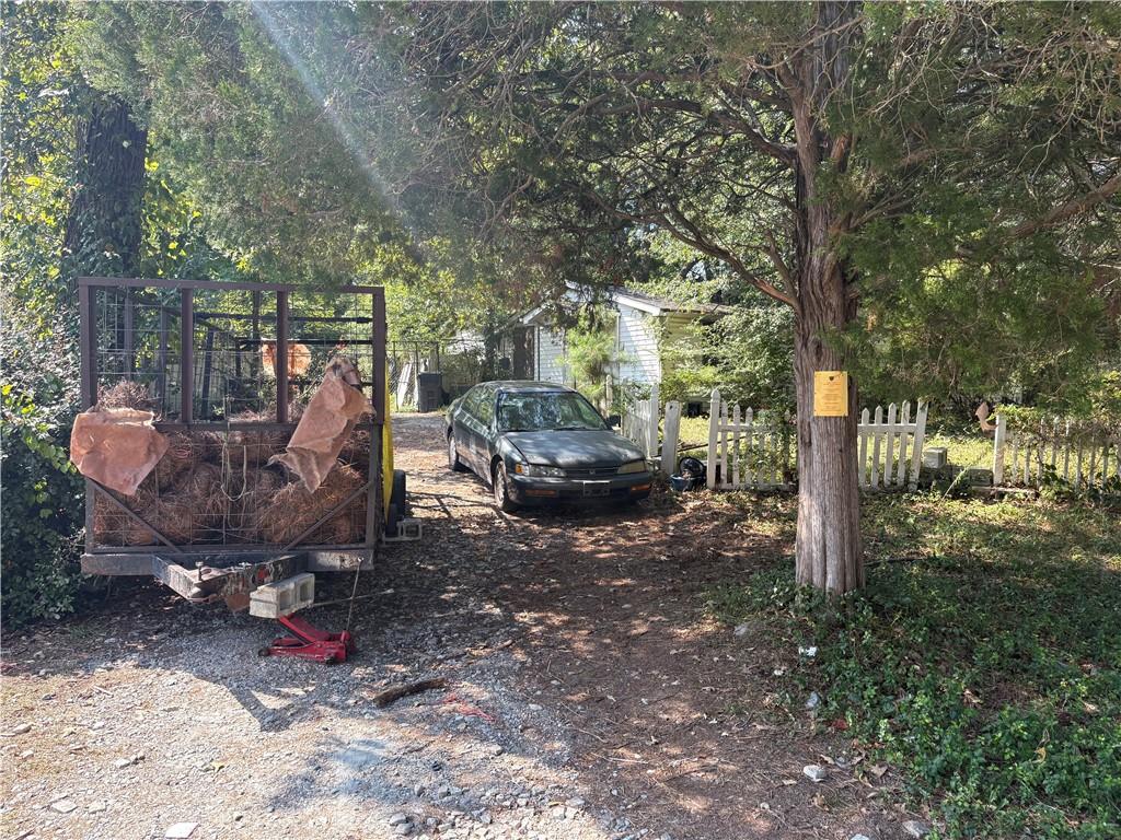 6355 Kimberly Mill Road South Fulton, GA 30349 - Photo 65 of 68 a view of a patio with table and chairs potted plants and large tree