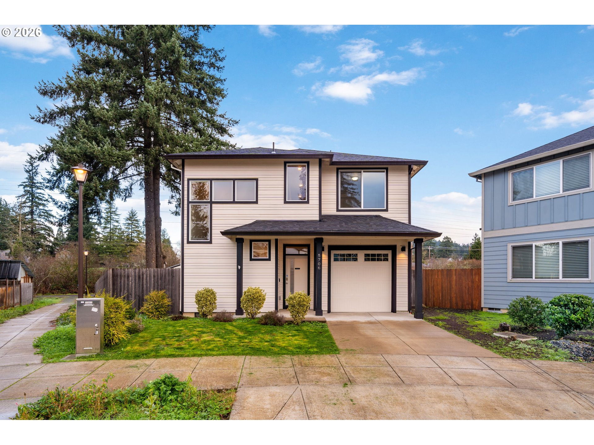 5706 Southeast 134th Place Portland, OR 97236 - Photo 1 of 39 a front view of a house with garden