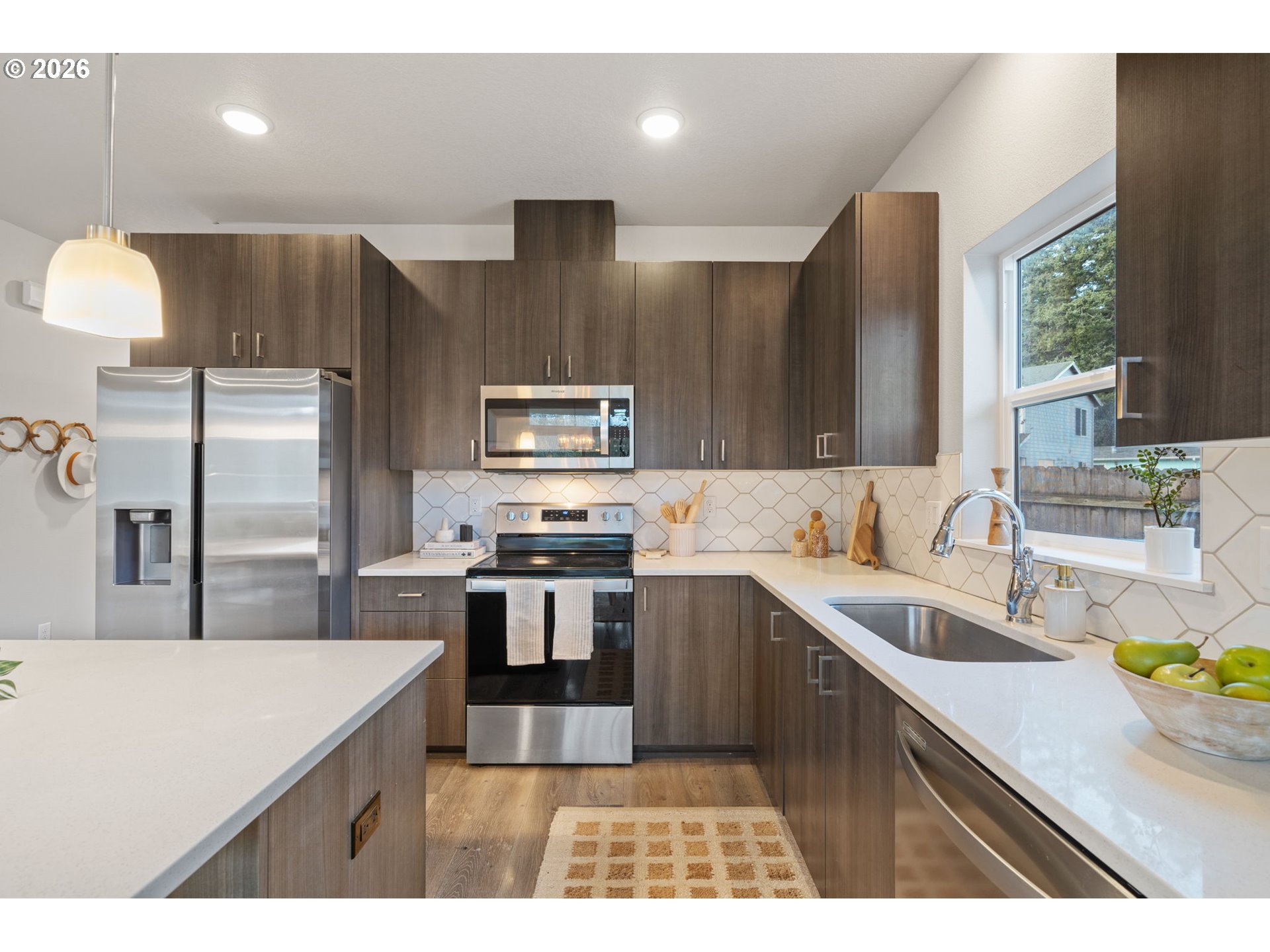 5706 Southeast 134th Place Portland, OR 97236 - Photo 11 of 39 a kitchen with stainless steel appliances a sink stove and refrigerator