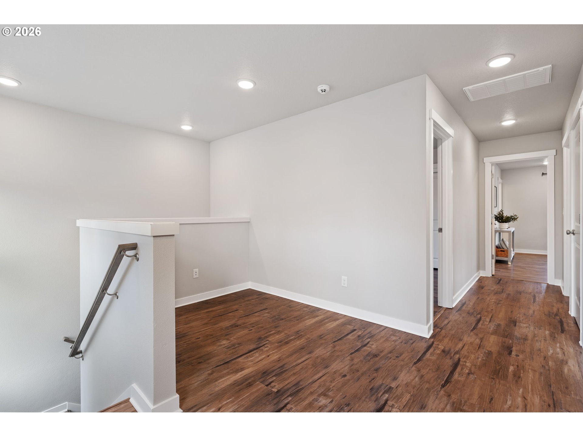 5706 Southeast 134th Place Portland, OR 97236 - Photo 17 of 39 a view of an empty room with wooden floor