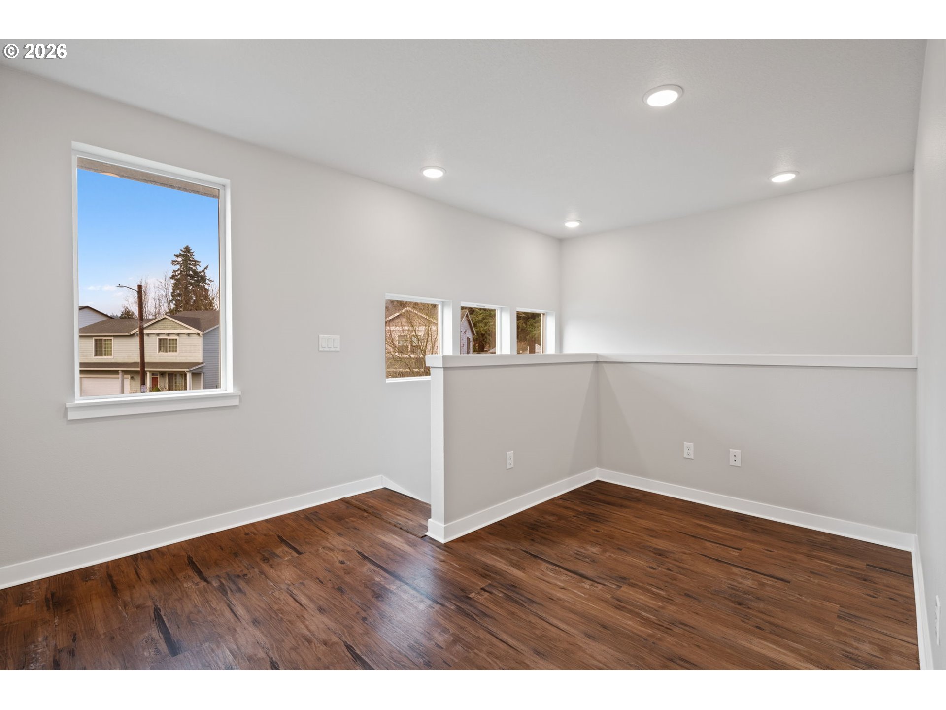 5706 Southeast 134th Place Portland, OR 97236 - Photo 18 of 39 a view of an empty room with wooden floor and a window