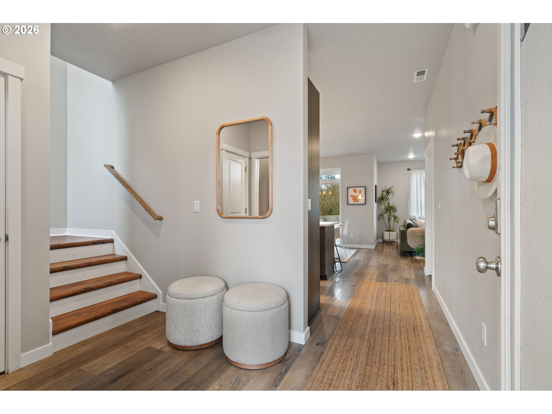 5706 Southeast 134th Place Portland, OR 97236 - Photo 2 of 39 a view of a hallway with wooden floor and furniture
