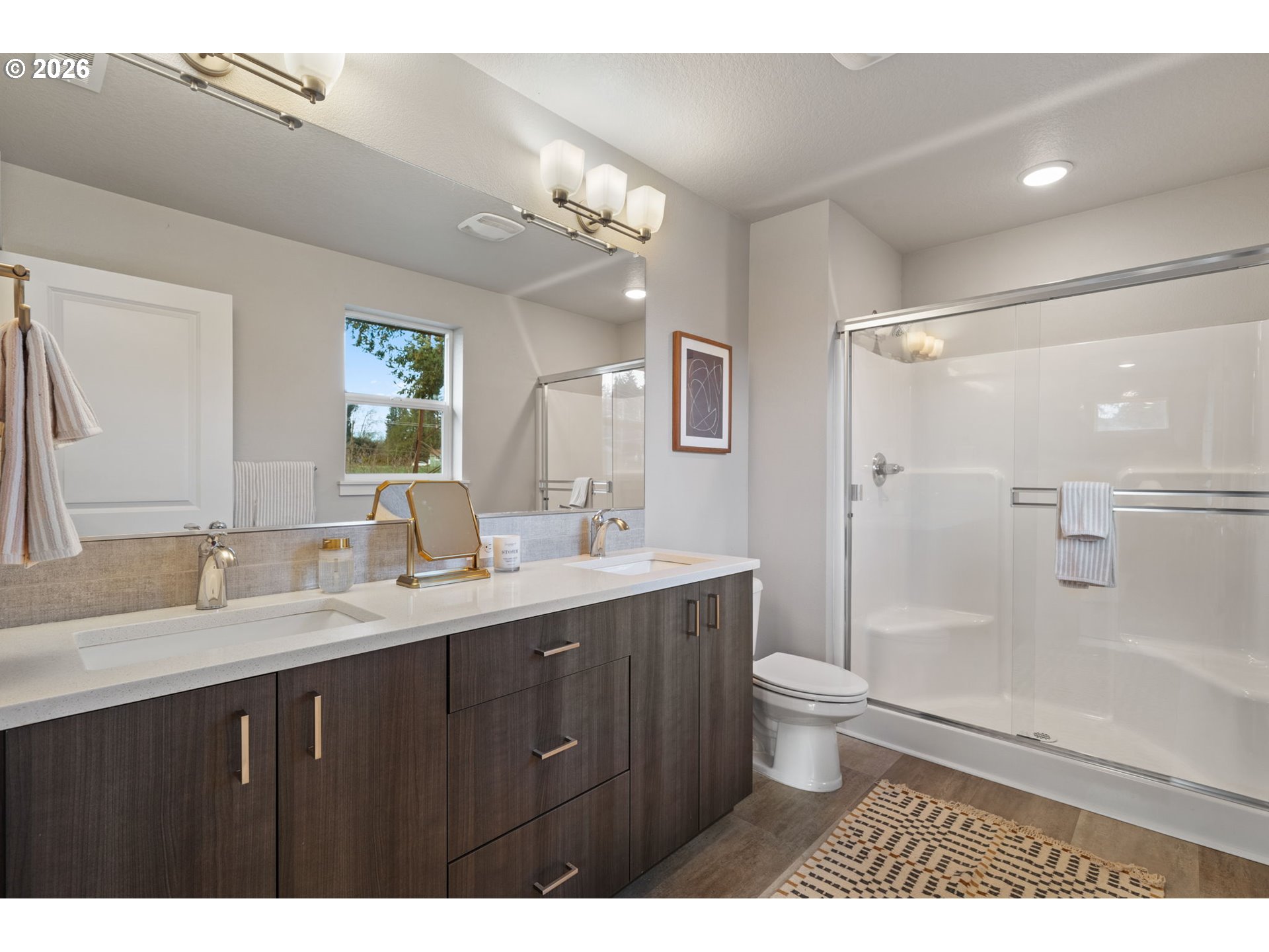 5706 Southeast 134th Place Portland, OR 97236 - Photo 23 of 39 a bathroom with a granite countertop sink toilet a large mirror a shower and a mirror