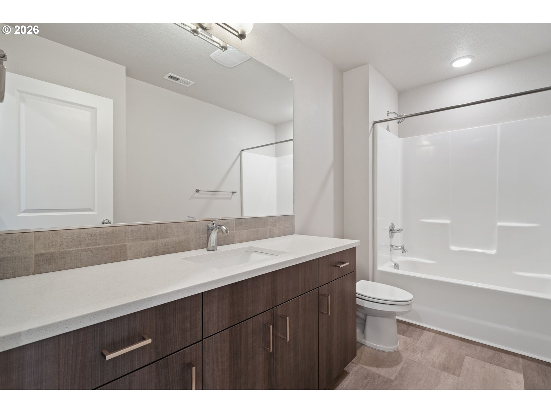 5706 Southeast 134th Place Portland, OR 97236 - Photo 31 of 39 a bathroom with a sink a toilet a mirror and bathtub