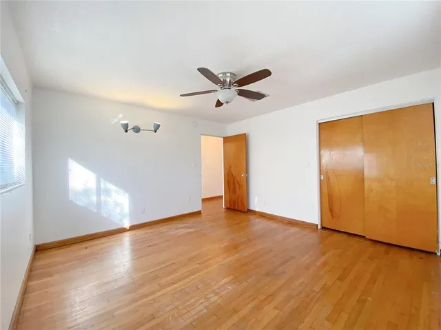 a bathroom with a toilet a sink a mirror a window and vanity