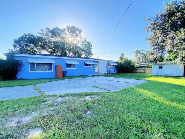 a view of a yard with a house in the background