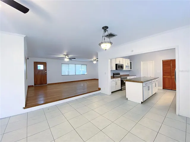 a kitchen with stainless steel appliances granite countertop a refrigerator a stove top oven a sink and dishwasher