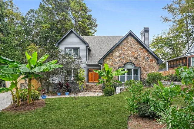 a front view of house with a garden